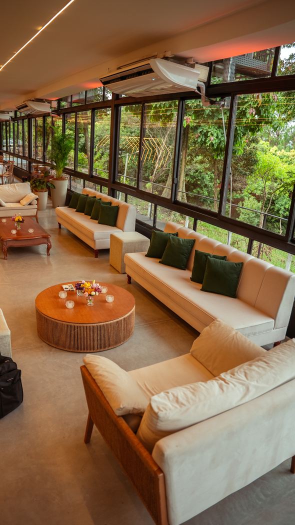 Lounge envidraçado cercado pelo verde
